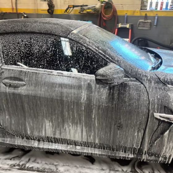 BMW M8 side during foam wash